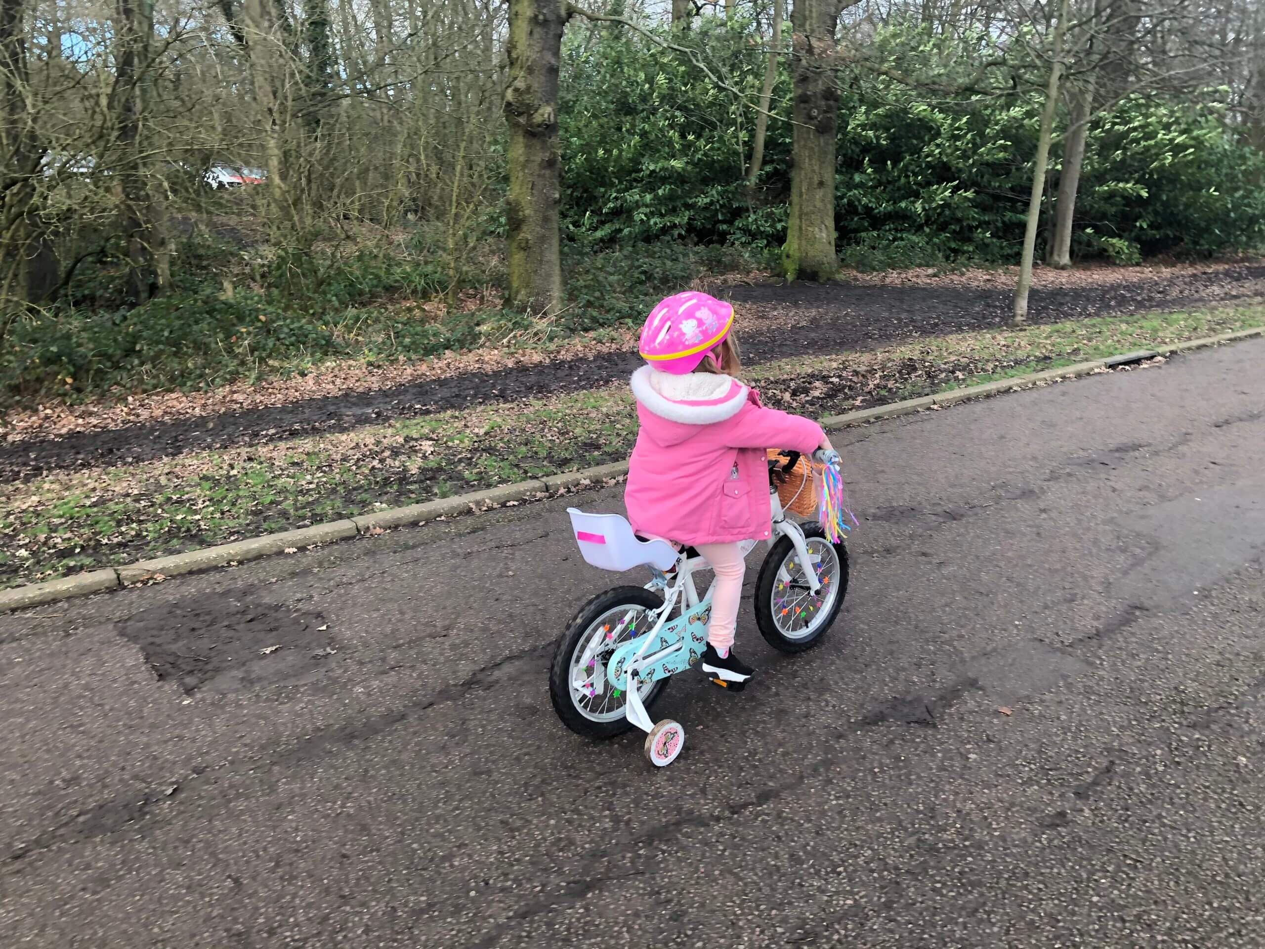 little girl riding bike at park