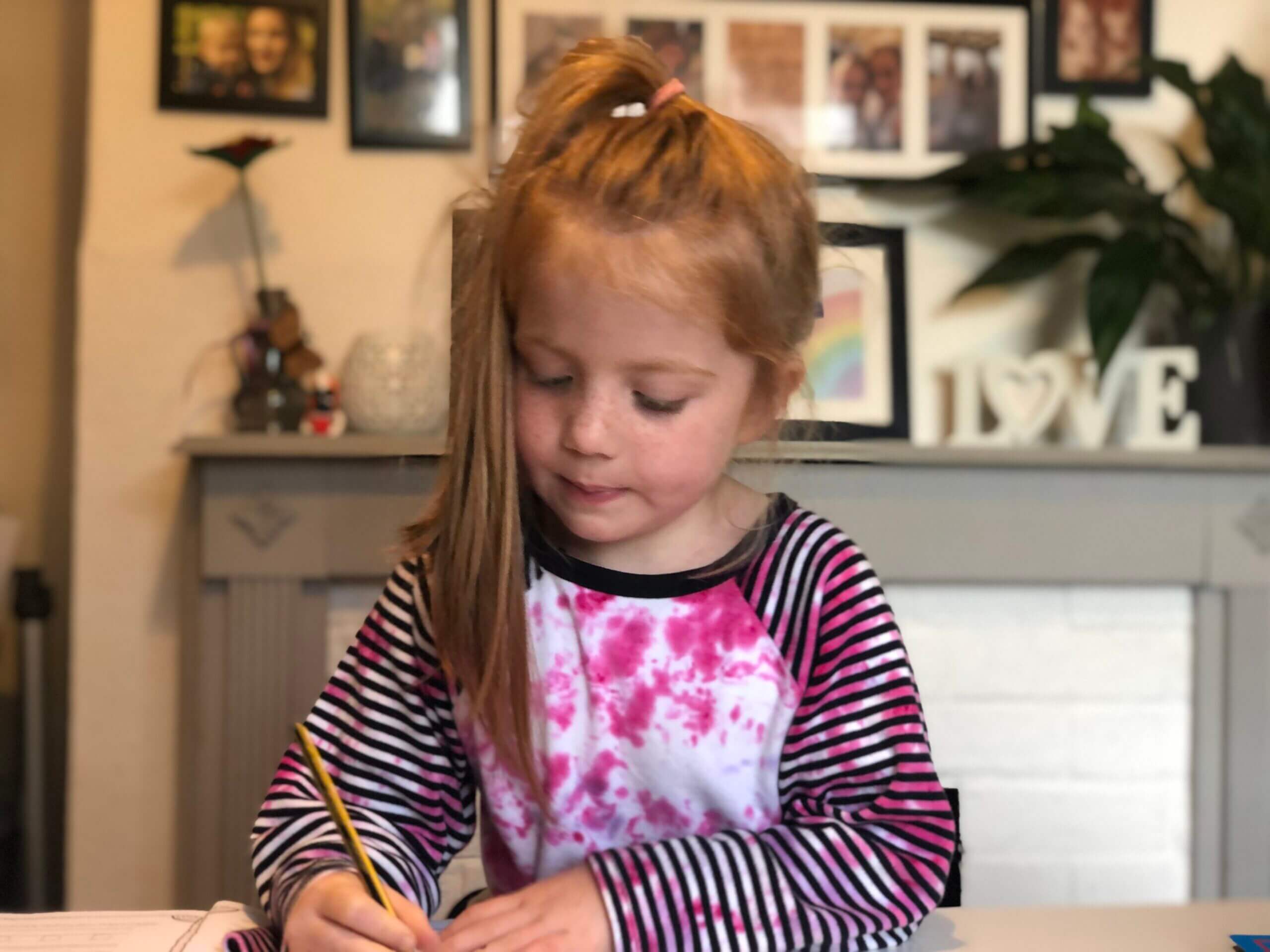 living arrows - little girl doing home learning